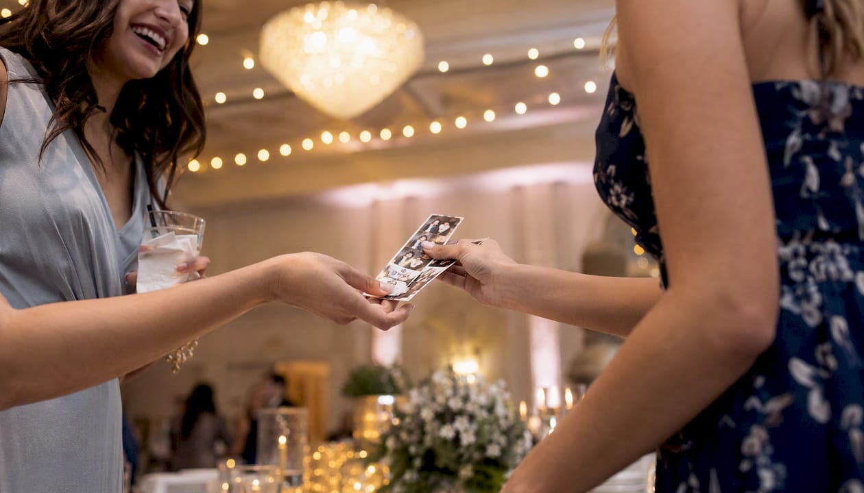 Guests exchanging personalized photo prints at event