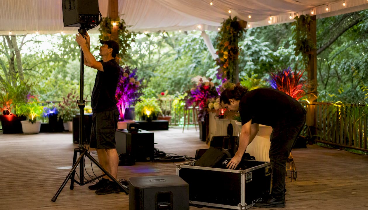 Event staff wiring AV equipment backstage